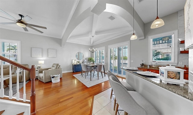 6545 Simone Shores Cir, Apollo Beach, FL 33572 - kitchen featuring a ceiling fan, a chandelier, light wood-style flooring, beam ceiling, and decorative light fixtures