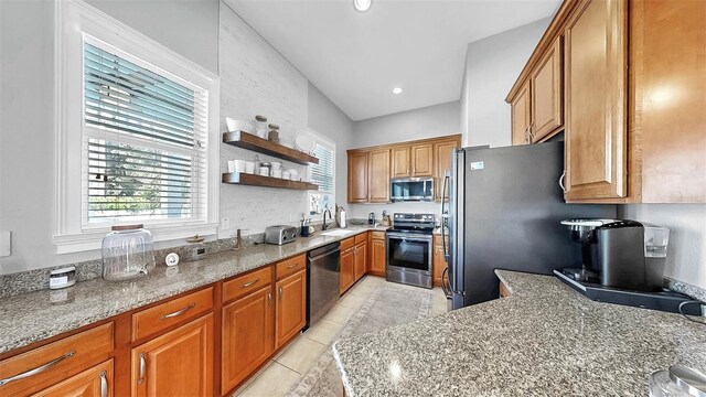 6545 Simone Shores Cir, Apollo Beach, FL 33572 - kitchen featuring stainless steel appliances, open shelves, light stone countertops, brown cabinets, and light tile patterned flooring