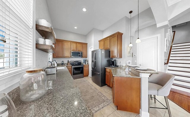 6545 Simone Shores Cir, Apollo Beach, FL 33572 - kitchen with stainless steel appliances, open shelves, a peninsula, brown cabinetry, and recessed lighting