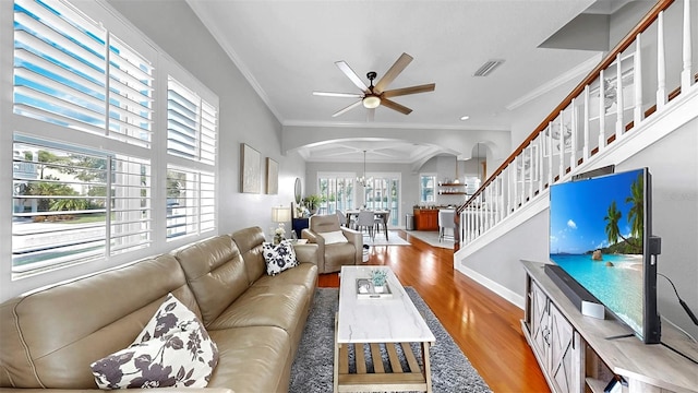 6545 Simone Shores Cir, Apollo Beach, FL 33572 - living area featuring arched walkways, wood finished floors, a ceiling fan, healthy amount of natural light, and ornamental molding