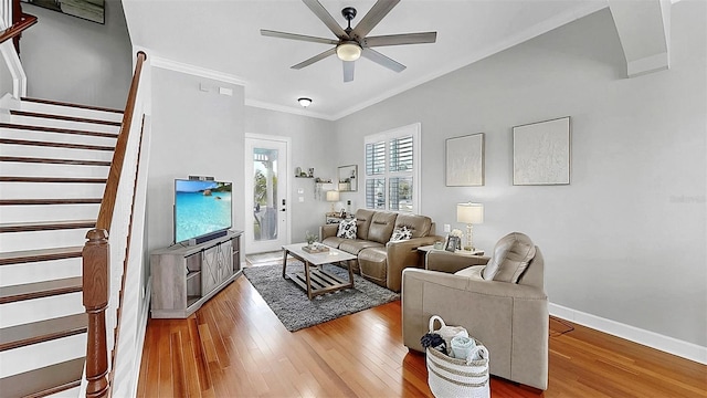 6545 Simone Shores Cir, Apollo Beach, FL 33572 - living room with crown molding, ceiling fan, stairway, and light wood-style flooring