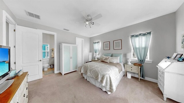 6545 Simone Shores Cir, Apollo Beach, FL 33572 - bedroom featuring light colored carpet, ceiling fan, and connected bathroom