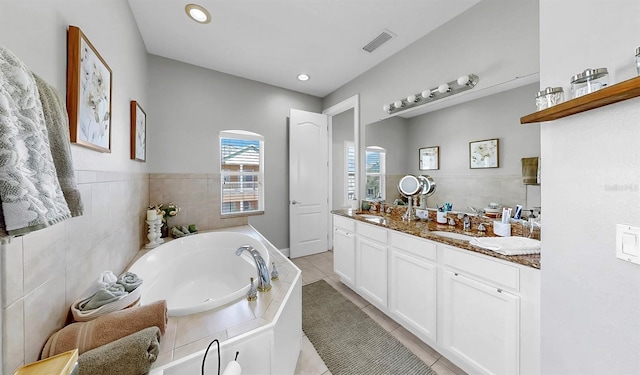 6545 Simone Shores Cir, Apollo Beach, FL 33572 - bathroom featuring tile patterned flooring, double vanity, a garden tub, and recessed lighting