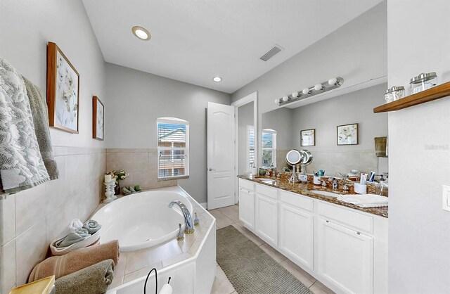 6545 Simone Shores Cir, Apollo Beach, FL 33572 - full bathroom with double vanity, a bath, tile patterned flooring, and recessed lighting