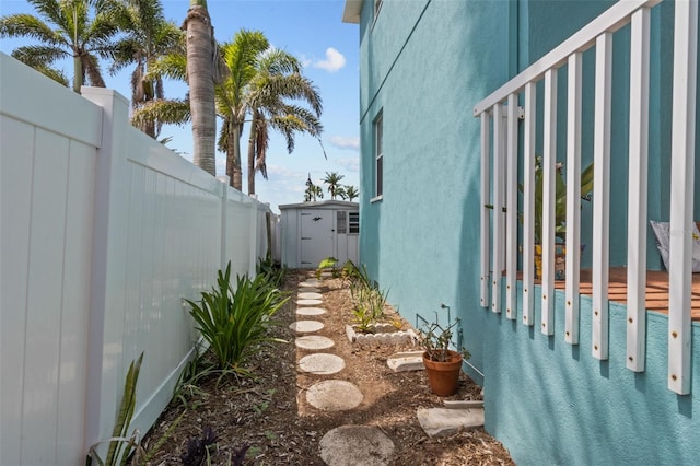 7950 Causeway Blvd N, Saint Petersburg, FL 33707 - view of property exterior with a shed, a fenced backyard, and stucco siding