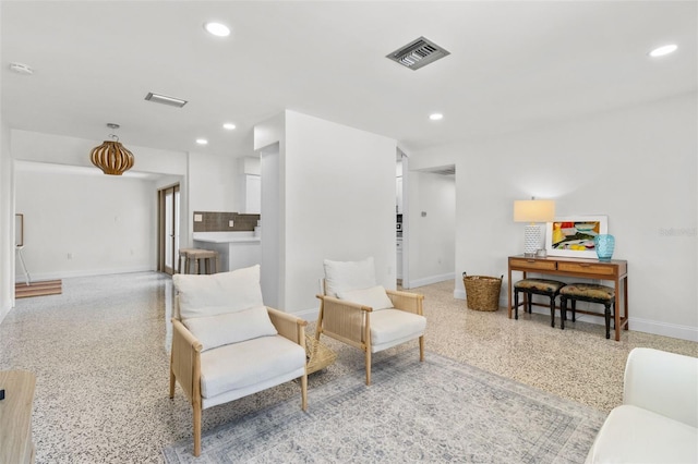 7950 Causeway Blvd N, Saint Petersburg, FL 33707 - living area featuring dark aggregate flooring, recessed lighting, and radiator heating unit