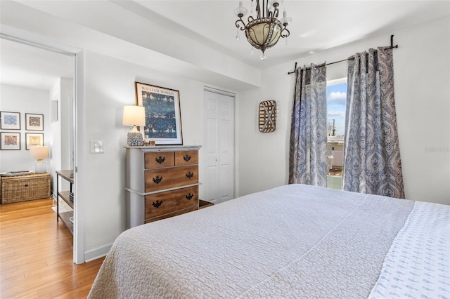 7950 Causeway Blvd N, Saint Petersburg, FL 33707 - bedroom with wood finished floors, a chandelier, and a closet