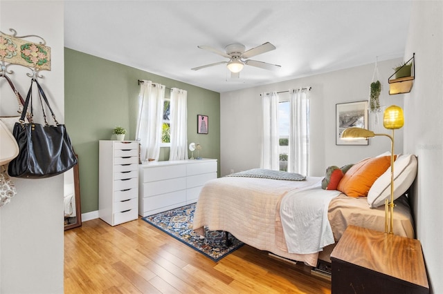 7950 Causeway Blvd N, Saint Petersburg, FL 33707 - bedroom featuring multiple windows, wood finished floors, and a ceiling fan