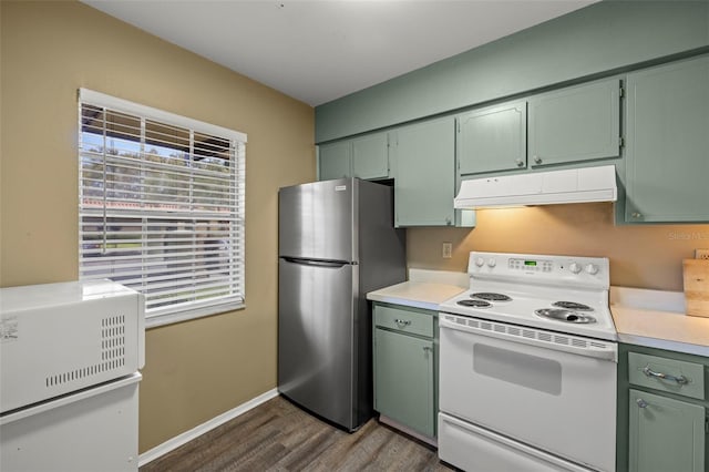 1701 Pinehurst Rd Unit 18D, Dunedin, FL 34698 - kitchen with electric stove, freestanding refrigerator, under cabinet range hood, and green cabinets