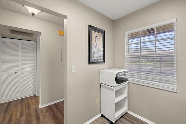 1701 Pinehurst Rd Unit 18D, Dunedin, FL 34698 - hall featuring wood finished floors and baseboards
