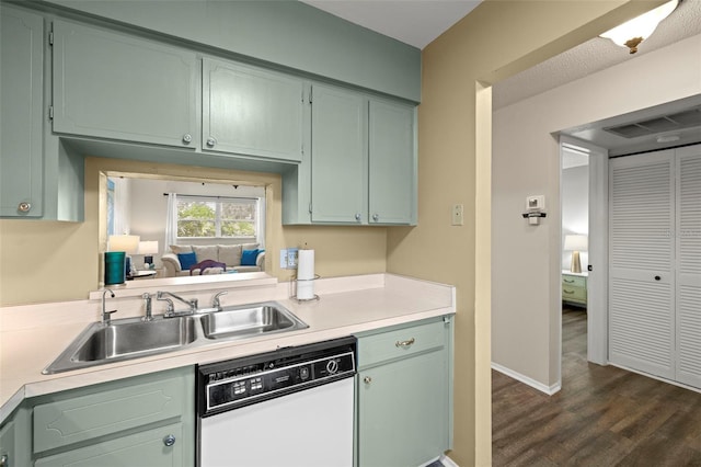 1701 Pinehurst Rd Unit 18D, Dunedin, FL 34698 - kitchen featuring white dishwasher, light countertops, dark wood-style flooring, and green cabinets