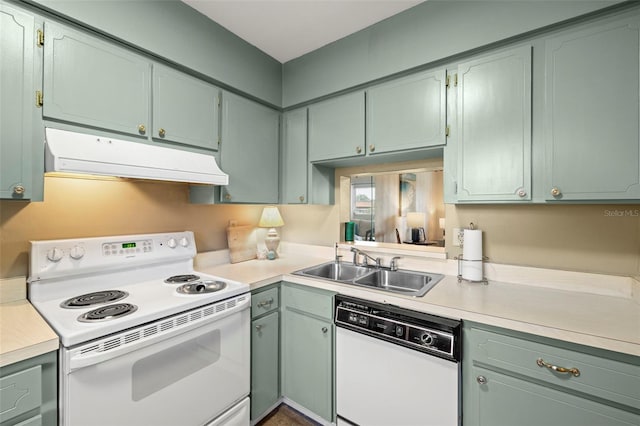 1701 Pinehurst Rd Unit 18D, Dunedin, FL 34698 - kitchen featuring white appliances, under cabinet range hood, light countertops, and green cabinetry