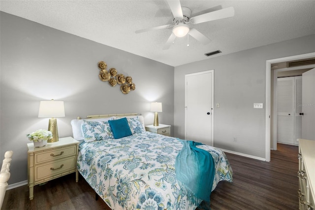 1701 Pinehurst Rd Unit 18D, Dunedin, FL 34698 - bedroom featuring dark wood-style floors, a textured ceiling, and ceiling fan