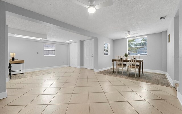 2614 W Idlewild Ave, Tampa, FL 33614 - dining space featuring a ceiling fan, a textured ceiling, plenty of natural light, and light tile patterned floors
