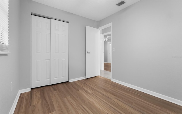 2614 W Idlewild Ave, Tampa, FL 33614 - unfurnished bedroom featuring wood finished floors and a closet
