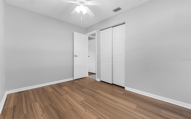 2614 W Idlewild Ave, Tampa, FL 33614 - unfurnished bedroom featuring wood finished floors, a closet, and ceiling fan