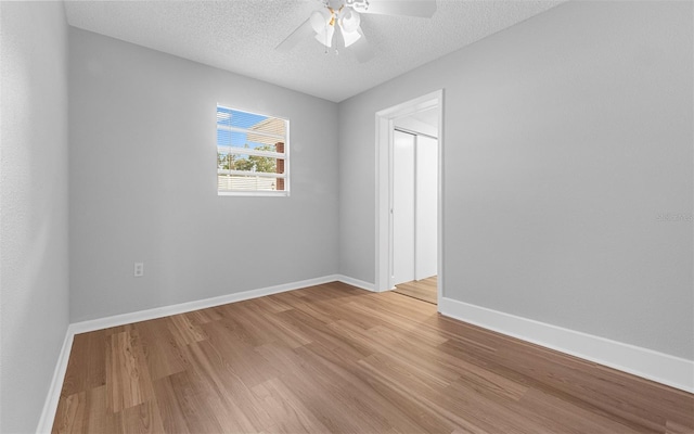 2614 W Idlewild Ave, Tampa, FL 33614 - unfurnished room featuring light wood finished floors, ceiling fan, and a textured ceiling