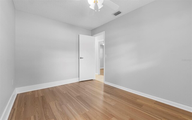 2614 W Idlewild Ave, Tampa, FL 33614 - spare room featuring light wood-style flooring, a ceiling fan, and a textured ceiling