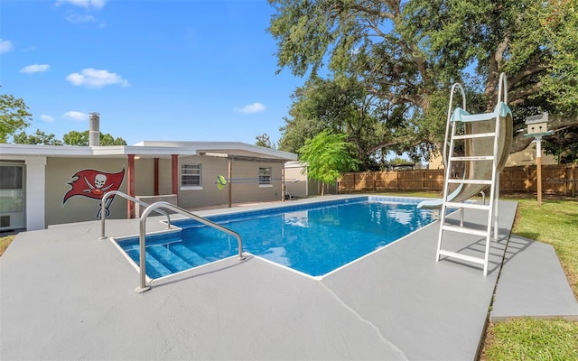 2614 W Idlewild Ave, Tampa, FL 33614 - view of pool with a water slide, a patio area, and a fenced backyard