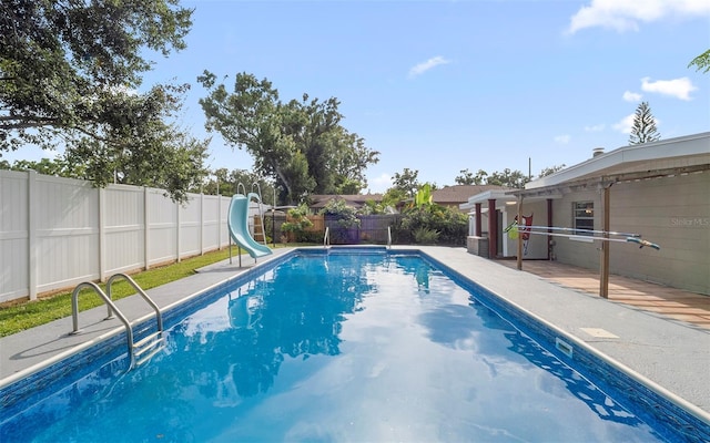 2614 W Idlewild Ave, Tampa, FL 33614 - view of pool featuring a water slide, a fenced backyard, and a patio