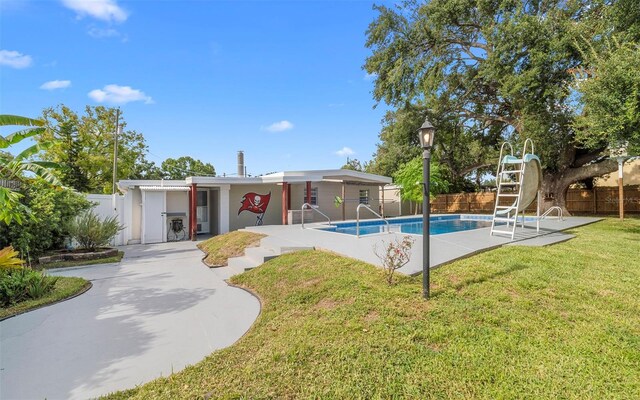 2614 W Idlewild Ave, Tampa, FL 33614 - view of pool with a water slide, a fenced backyard, and a patio area
