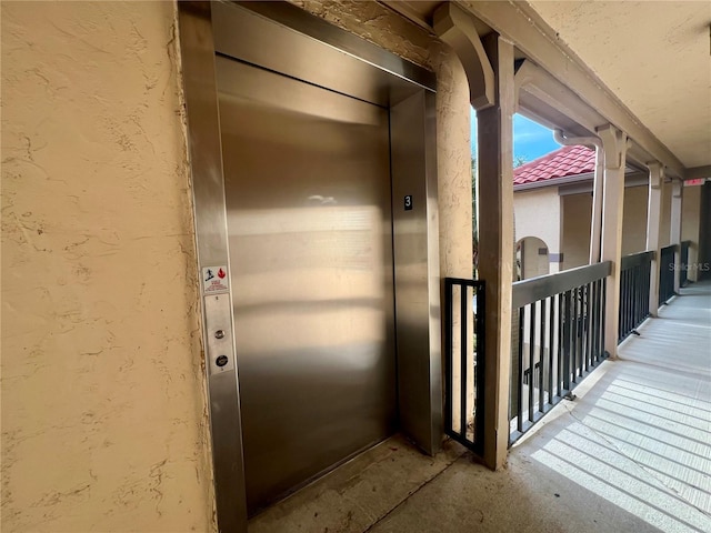 2400 Feather Sound Dr Unit 935, Clearwater, FL 33762 - doorway to property featuring elevator and stucco siding