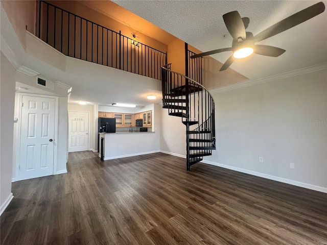 2400 Feather Sound Dr Unit 935, Clearwater, FL 33762 - unfurnished living room with a ceiling fan, stairway, dark wood finished floors, crown molding, and a towering ceiling