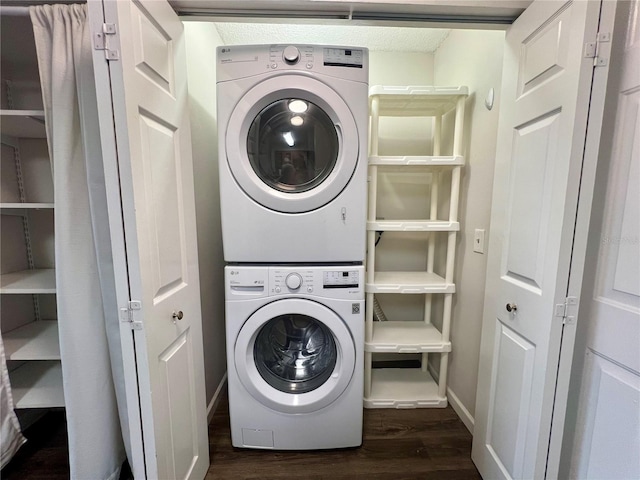 2400 Feather Sound Dr Unit 935, Clearwater, FL 33762 - washroom featuring stacked washer / dryer and dark wood-style flooring