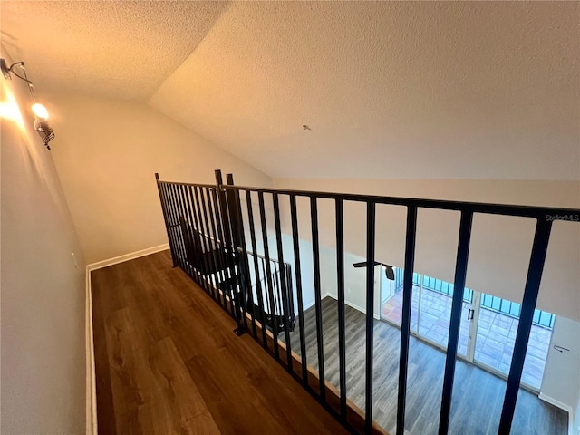 2400 Feather Sound Dr Unit 935, Clearwater, FL 33762 - stairway with lofted ceiling, wood finished floors, and a textured ceiling