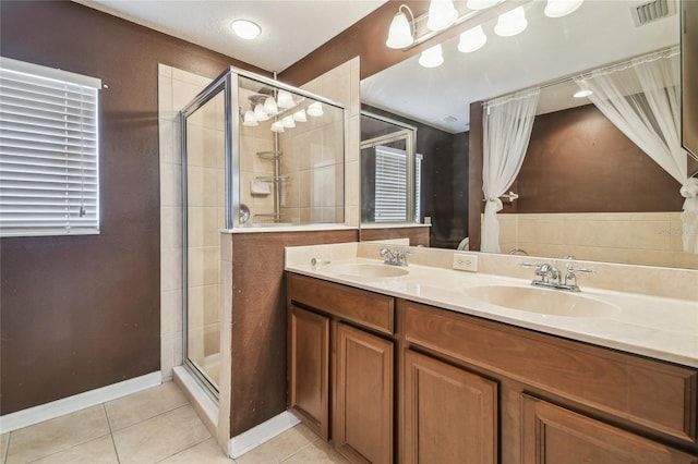 10343 Avelar Ridge Dr, Riverview, FL 33578 - bathroom with tile patterned floors, a shower stall, and double vanity