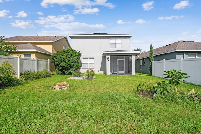 10343 Avelar Ridge Dr, Riverview, FL 33578 - rear view of house with a sunroom, a fenced backyard, stucco siding, and roof mounted solar panels