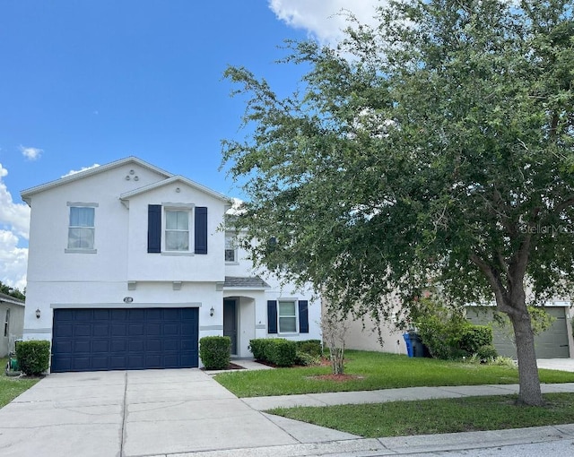 7618 Tangle Rush Dr, Gibsonton, FL 33534 - view of front of property featuring stucco siding, concrete driveway, an attached garage, and a front lawn
