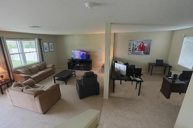 7618 Tangle Rush Dr, Gibsonton, FL 33534 - living room featuring a textured ceiling, light tile patterned flooring, and light carpet