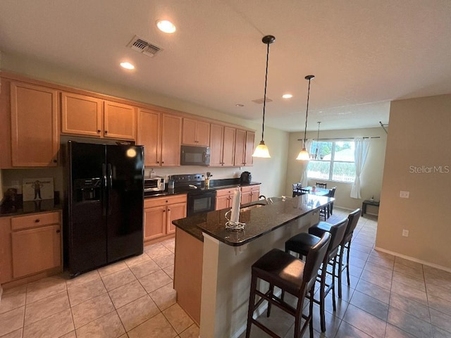 7618 Tangle Rush Dr, Gibsonton, FL 33534 - kitchen featuring black appliances, dark countertops, a breakfast bar, recessed lighting, and a center island with sink