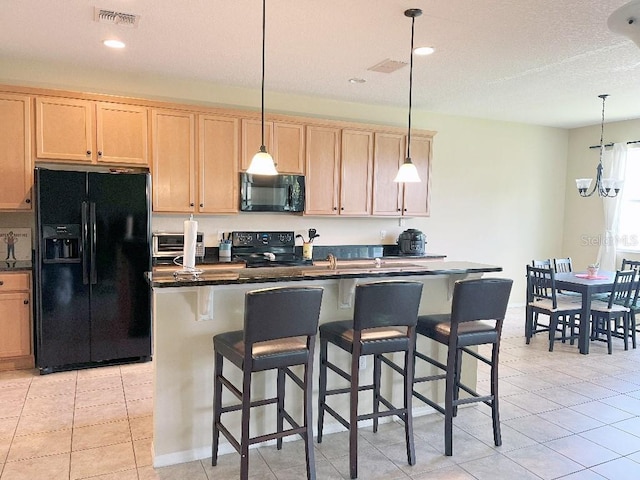 7618 Tangle Rush Dr, Gibsonton, FL 33534 - kitchen featuring black appliances, dark countertops, light brown cabinets, a kitchen island with sink, and recessed lighting