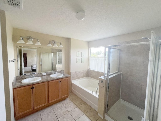 7618 Tangle Rush Dr, Gibsonton, FL 33534 - full bathroom with a garden tub, tile patterned floors, a shower stall, and double vanity