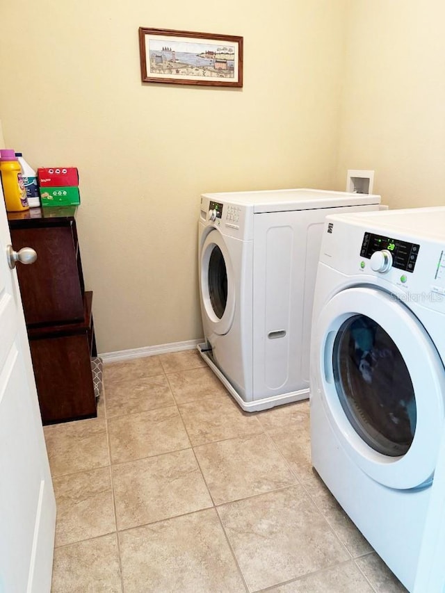 7618 Tangle Rush Dr, Gibsonton, FL 33534 - washroom with washer and dryer and light tile patterned floors
