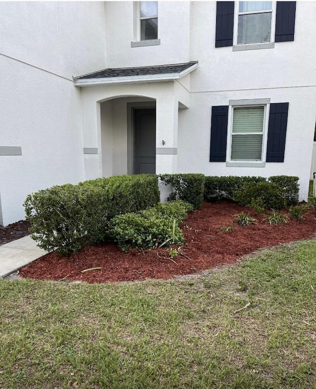 7618 Tangle Rush Dr, Gibsonton, FL 33534 - doorway to property with stucco siding and a yard