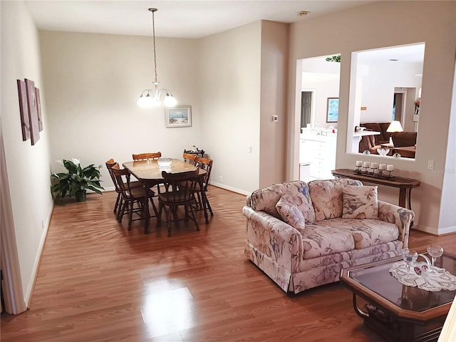 3740 Emerald Ln, Mulberry, FL 33860 - living room featuring wood finished floors and a chandelier