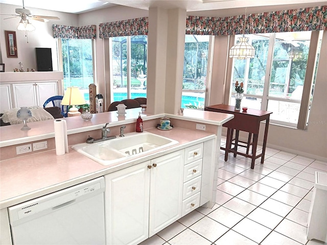3740 Emerald Ln, Mulberry, FL 33860 - kitchen featuring white dishwasher, light countertops, white cabinets, and light tile patterned flooring