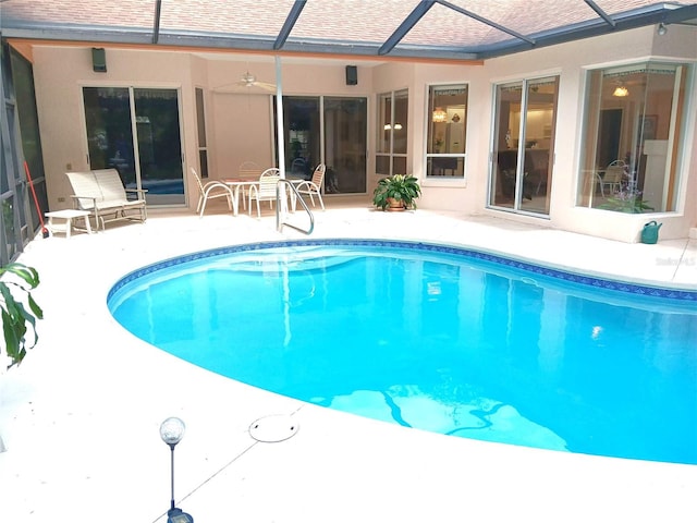 3740 Emerald Ln, Mulberry, FL 33860 - outdoor pool featuring a patio area, glass enclosure, and a ceiling fan