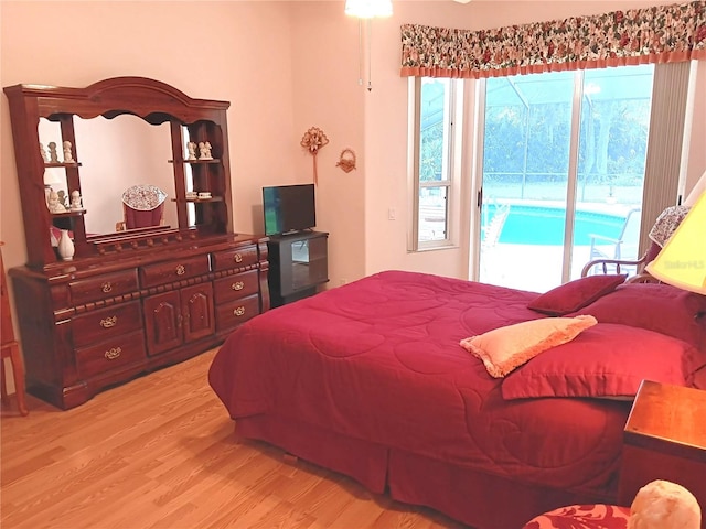 3740 Emerald Ln, Mulberry, FL 33860 - bedroom with access to exterior and light wood-style flooring