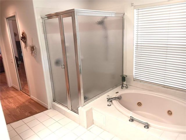 3740 Emerald Ln, Mulberry, FL 33860 - bathroom featuring a shower stall, a tub with jets, and wood finished floors