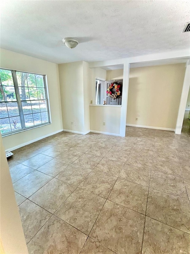 17017 Paula Ln, Lutz, FL 33558 - unfurnished room with a textured ceiling and tile patterned floors
