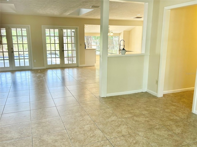 17017 Paula Ln, Lutz, FL 33558 - empty room featuring french doors and light tile patterned floors