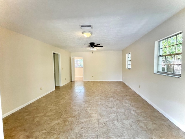 17017 Paula Ln, Lutz, FL 33558 - unfurnished room with healthy amount of natural light, a ceiling fan, and a textured ceiling