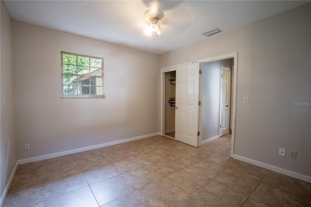 17017 Paula Ln, Lutz, FL 33558 - unfurnished bedroom with a closet, a ceiling fan, and light tile patterned floors