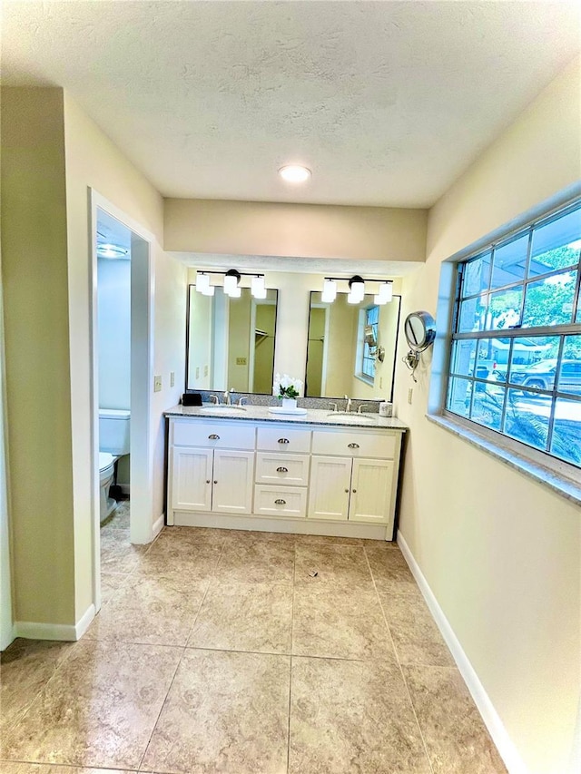 17017 Paula Ln, Lutz, FL 33558 - full bathroom with double vanity, a textured ceiling, and tile patterned flooring