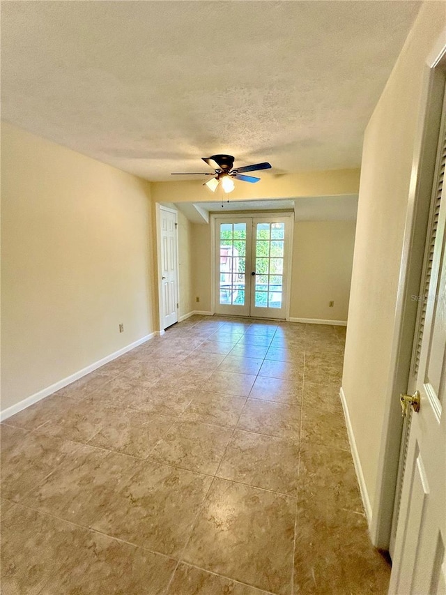 17017 Paula Ln, Lutz, FL 33558 - spare room with french doors, a textured ceiling, a ceiling fan, and tile patterned floors