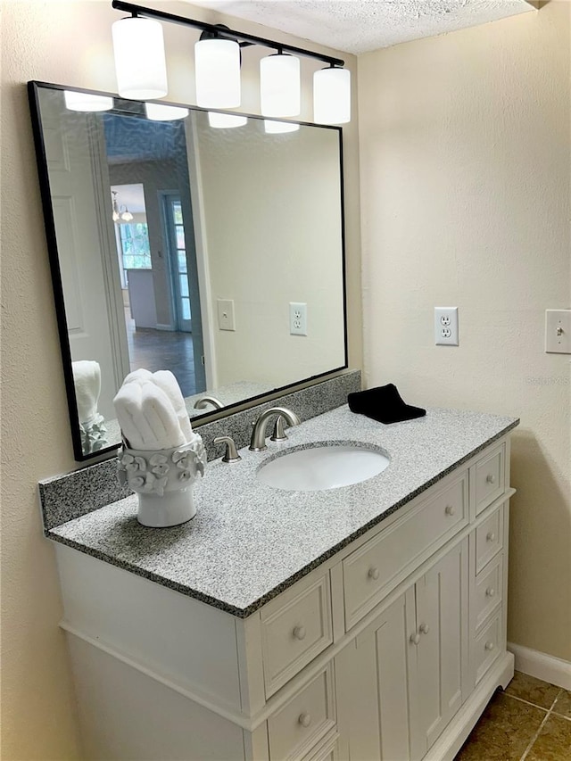 17017 Paula Ln, Lutz, FL 33558 - bathroom with vanity, a textured ceiling, and tile patterned floors